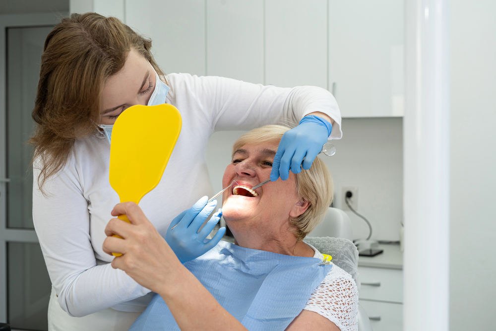 Carer supporting an older patient during a dental appointment