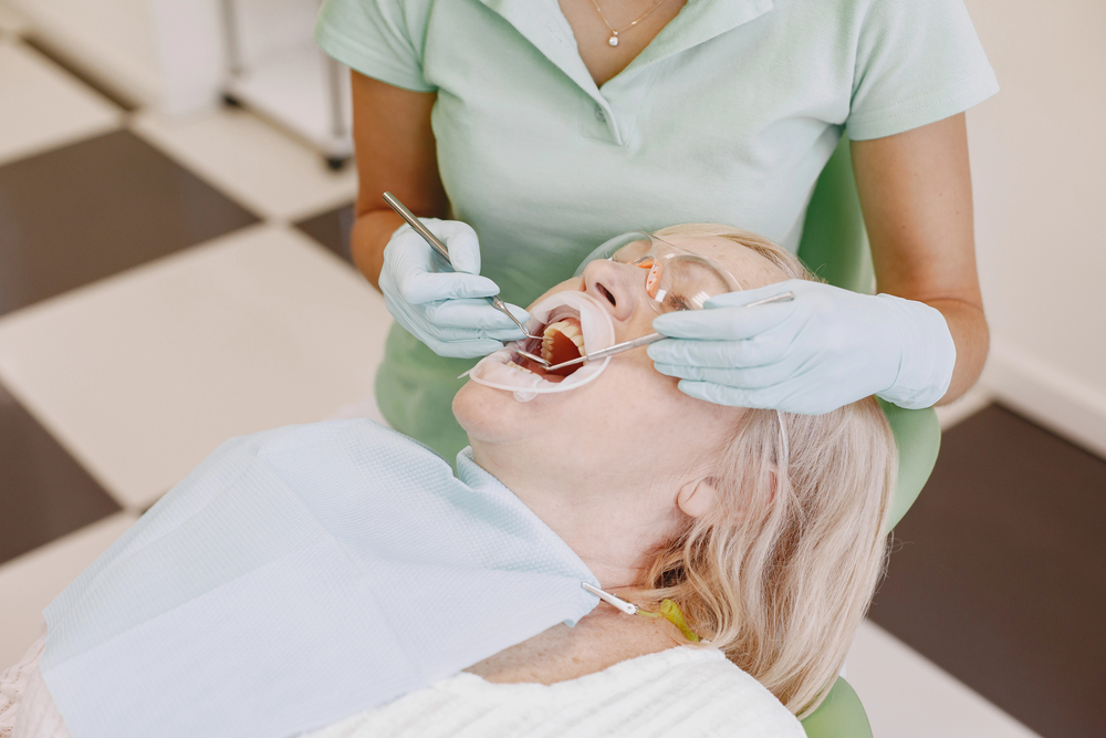 Dentist discussing individual dental care needs with an older patient