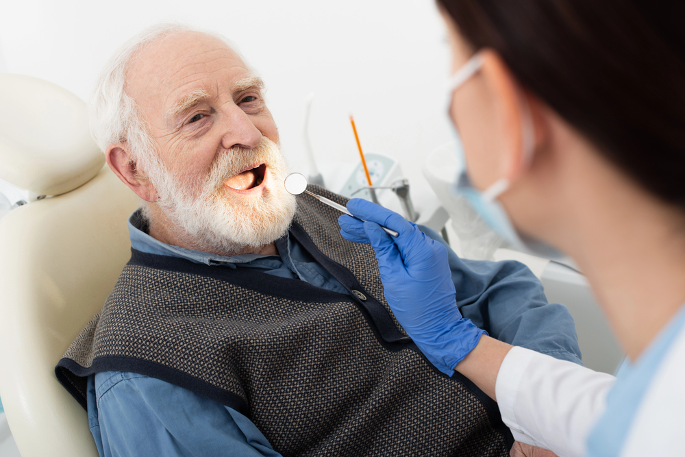 Dentist providing dental care to an older person during a home visit