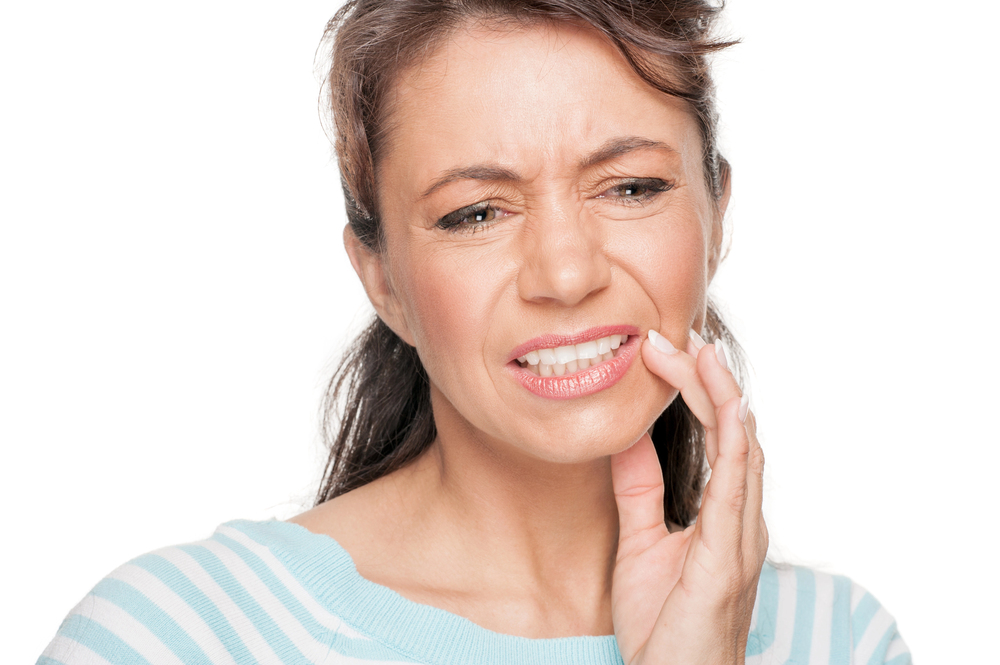 Woman experiencing dry mouth during menopause