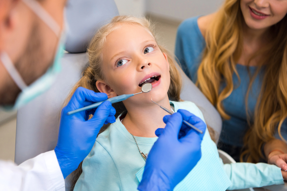 Dentist discussing children’s tooth decay with a family in Frenchs Forest