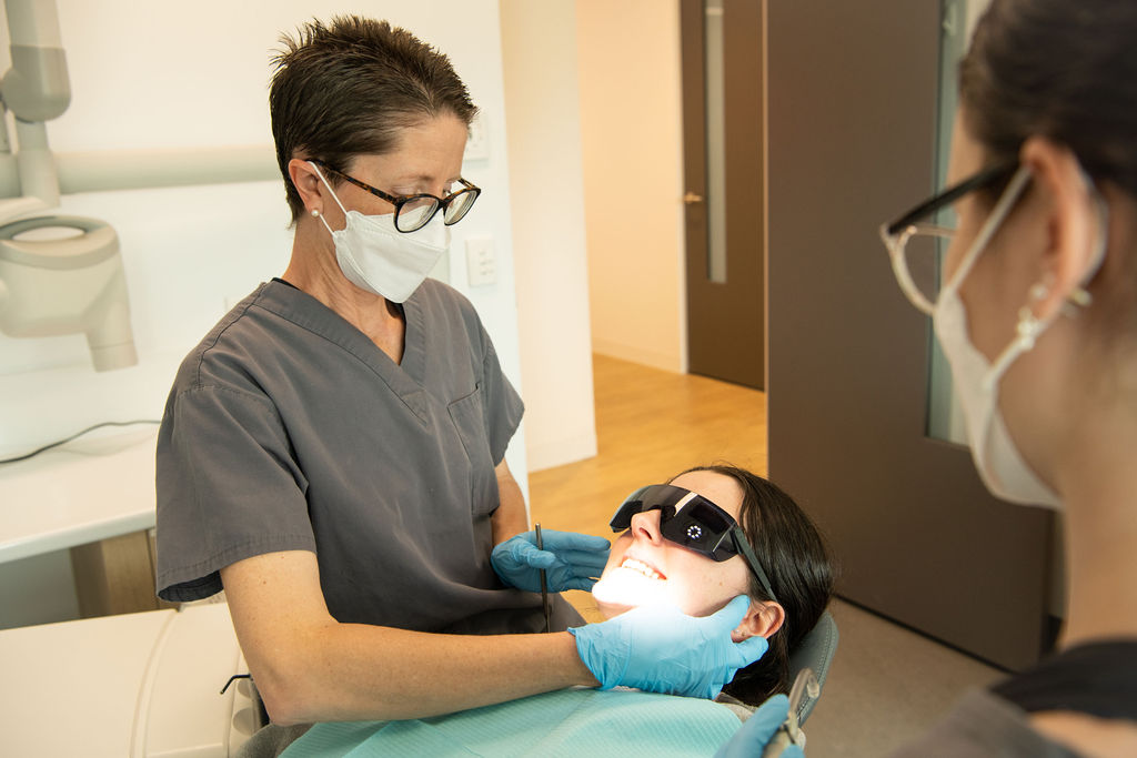 Dr Sara discussing menopause-related oral health changes with a patient